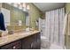 Stylish bathroom featuring a granite countertop, wood vanity, and a shower-tub combination for modern comfort at 76 Mariners Cay Dr, Folly Beach, SC 29439