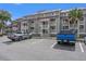 Multi-Gathering gray condominiums building with parking lot at 76 Mariners Cay Dr, Folly Beach, SC 29439