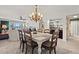 Bright dining room featuring seating for six, stylish light fixture, and convenient access to the kitchen at 76 Mariners Cay Dr, Folly Beach, SC 29439