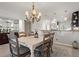 Bright dining room features a decorative chandelier, seating for six, and a stylish wet bar area at 76 Mariners Cay Dr, Folly Beach, SC 29439