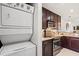 Efficient kitchen layout featuring stacked washer and dryer, stainless appliances, and granite countertops at 76 Mariners Cay Dr, Folly Beach, SC 29439