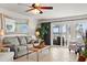 Bright living room featuring cozy seating, a decorative mirror and large sliding doors to the outside at 76 Mariners Cay Dr, Folly Beach, SC 29439