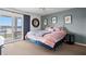 Comfortable bedroom featuring a large bed, stylish decor, and sliding glass doors to a private balcony with waterfront views at 76 Mariners Cay Dr, Folly Beach, SC 29439