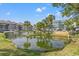 Scenic pond view surrounded by manicured grounds, palm trees and complex buildings at 76 Mariners Cay Dr, Folly Beach, SC 29439