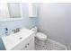 Bathroom features white vanity, marble floors, and blue painted walls at 8 Darien Dr, Charleston, SC 29414