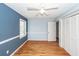 Blue bedroom features hardwood floors, a window, and ample closet space at 8 Darien Dr, Charleston, SC 29414