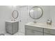 Stylish bathroom featuring dual vanities with round mirrors and modern fixtures at 824 Forrest Dr, Charleston, SC 29492