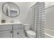 Clean bathroom with a vanity, round mirror, and shower-tub combination with a striped curtain at 824 Forrest Dr, Charleston, SC 29492