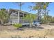 Open-air cabana with screened walls, offering shade and views of the surrounding landscape at 824 Forrest Dr, Charleston, SC 29492