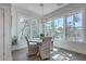 Cozy dining area with a round table, four chairs, chandelier lighting and bright natural light at 824 Forrest Dr, Charleston, SC 29492