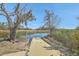 Tranquil view of a private dock leading to calm waters, surrounded by lush vegetation and serene landscape at 824 Forrest Dr, Charleston, SC 29492
