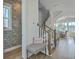 Inviting entryway with a fish-themed wallpaper, a striped bench and stairs leading to the upper level at 824 Forrest Dr, Charleston, SC 29492