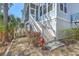 Charming coastal home featuring a screened porch, white stairs, and vibrant landscaping at 824 Forrest Dr, Charleston, SC 29492
