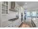 Modern kitchen featuring stainless steel appliances, custom cabinets, and open design flowing into living space at 824 Forrest Dr, Charleston, SC 29492