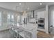Bright kitchen featuring a spacious island with bar seating, stainless steel appliances, and stylish lighting at 824 Forrest Dr, Charleston, SC 29492