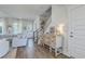 Bright living room showcasing hardwood floors, comfortable seating, and abundant natural light from large windows at 824 Forrest Dr, Charleston, SC 29492