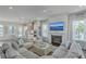 Bright living room with fireplace, large windows, and comfortable seating, flowing into modern kitchen at 824 Forrest Dr, Charleston, SC 29492
