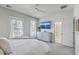Comfortable main bedroom with a TV, ample natural light, and a glimpse into the ensuite bathroom at 824 Forrest Dr, Charleston, SC 29492