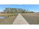 Marsh view with a wooden boardwalk leading into a scenic landscape, providing a natural retreat at 824 Forrest Dr, Charleston, SC 29492