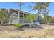 Charming screened porch provides serene outdoor living with views of lush tropical landscaping at 824 Forrest Dr, Charleston, SC 29492