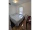 A cozy bedroom with a double bed, natural light and a side table at 824 Orangeburg Rd, Summerville, SC 29483