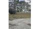 A cute single-story home with lots of trees in a spacious front yard at 824 Orangeburg Rd, Summerville, SC 29483