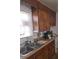 This kitchen offers a window over the sink, and dark wood cabinets at 824 Orangeburg Rd, Summerville, SC 29483