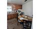 The kitchen features wood cabinets, a window, a small eating area, and a basic stove at 824 Orangeburg Rd, Summerville, SC 29483