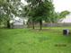 Large, grassy backyard with trees and a wooden fence, offering a serene outdoor space at 8309 Berringer Bluff, North Charleston, SC 29418