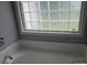 Bright bathroom featuring a garden tub with tiled surround and a window at 8309 Berringer Bluff, North Charleston, SC 29418