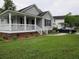Charming home with a covered porch, a well-maintained lawn, and a paved driveway at 8309 Berringer Bluff, North Charleston, SC 29418