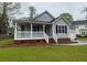 Charming single-Gathering home with a inviting covered front porch and well-manicured lawn at 8309 Berringer Bluff, North Charleston, SC 29418