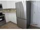 Modern kitchen with stainless steel refrigerator and white cabinetry at 8309 Berringer Bluff, North Charleston, SC 29418