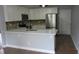 Well-equipped kitchen with white cabinets, stainless steel appliances, and a breakfast bar at 8309 Berringer Bluff, North Charleston, SC 29418