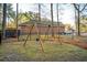 Swing set in a spacious backyard with a wrought iron fence surrounding the yard at 8716 Dover Creek St, North Charleston, SC 29420