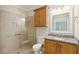 Bathroom featuring a glass-enclosed shower and wooden vanity at 8716 Dover Creek St, North Charleston, SC 29420