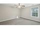 Bright bedroom with a ceiling fan and natural light streaming through a window at 8716 Dover Creek St, North Charleston, SC 29420