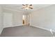 Spacious bedroom with gray carpet, ceiling fan, and white trim at 8716 Dover Creek St, North Charleston, SC 29420