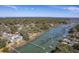 Aerial view showcases the waterfront property with private dock surrounded by lush greenery and serene marshland views at 886 Piccadilly Cir, Charleston, SC 29412