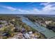 Aerial view showcases the waterfront property with private dock surrounded by lush greenery and serene marshland views at 886 Piccadilly Cir, Charleston, SC 29412