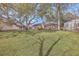 Large backyard with mature trees, a brick home, wooden deck and plenty of room for recreation and relaxation at 886 Piccadilly Cir, Charleston, SC 29412
