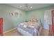 Inviting bedroom featuring mint green walls, bright windows, ceiling fan, and tasteful decor at 886 Piccadilly Cir, Charleston, SC 29412