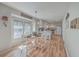 Bright dining area with wood floors, complemented by a modern chandelier, is next to the kitchen at 886 Piccadilly Cir, Charleston, SC 29412