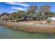 Picturesque waterfront property surrounded by lush trees offering privacy and a serene atmosphere at 886 Piccadilly Cir, Charleston, SC 29412