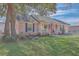 Beautiful brick home featuring a cozy porch with a swing and a lush green lawn at 886 Piccadilly Cir, Charleston, SC 29412
