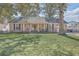 Charming brick home with an inviting front porch, classic shutters, and a well-manicured lawn at 886 Piccadilly Cir, Charleston, SC 29412