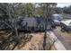 Inviting brick home featuring a covered porch and attached garage, with mature trees in a landscaped yard at 886 Piccadilly Cir, Charleston, SC 29412