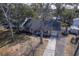Charming brick home featuring a cozy front porch and attached garage, nestled among mature trees at 886 Piccadilly Cir, Charleston, SC 29412