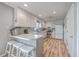 Modern kitchen with white cabinets, stainless steel appliances, and a stylish breakfast bar with stools at 886 Piccadilly Cir, Charleston, SC 29412