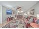 Inviting living room featuring cozy leather sofas, a ceiling fan, and wood floors with a decorative rug at 886 Piccadilly Cir, Charleston, SC 29412